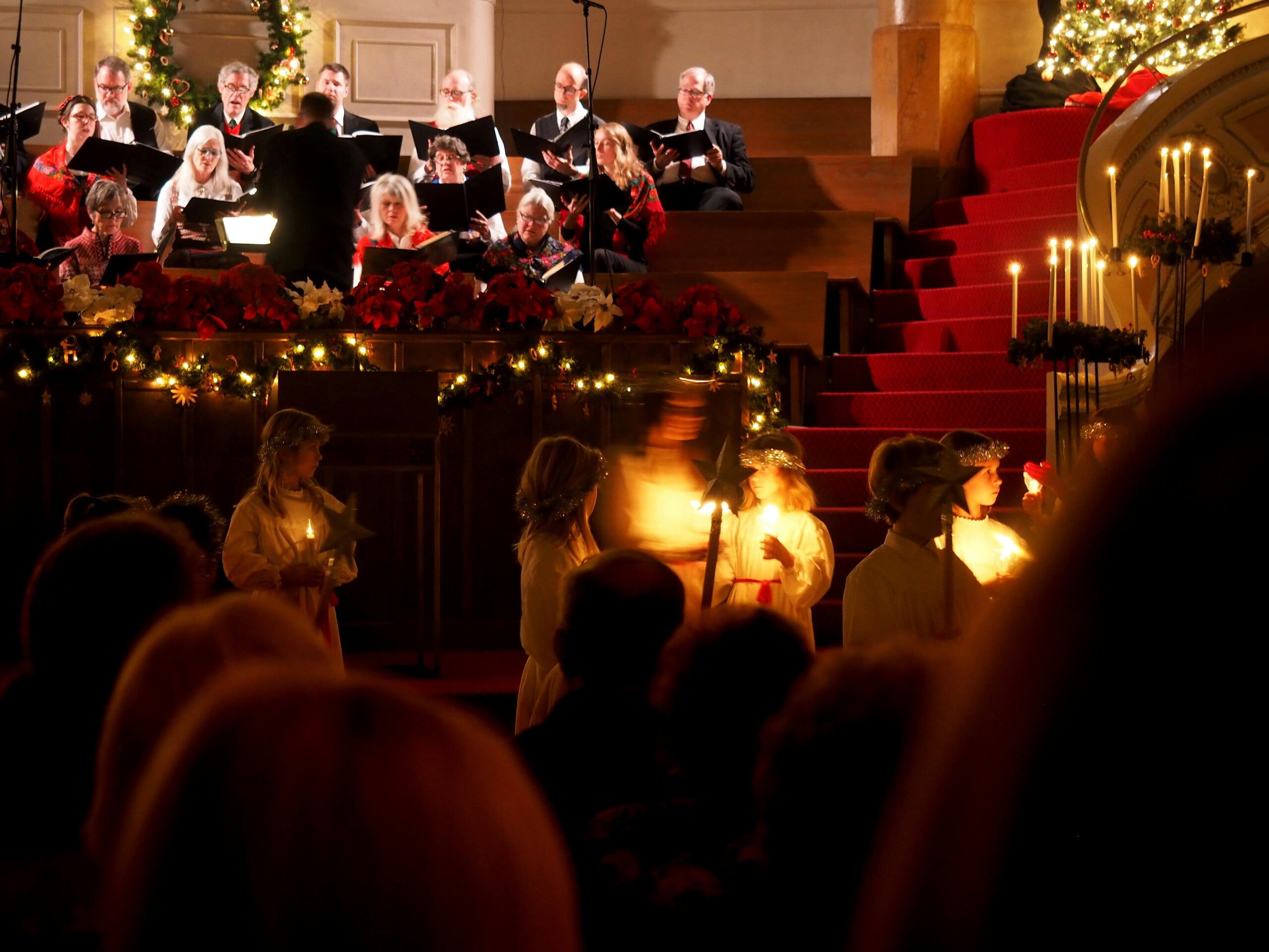 christmas carollers singing during candlelit concert