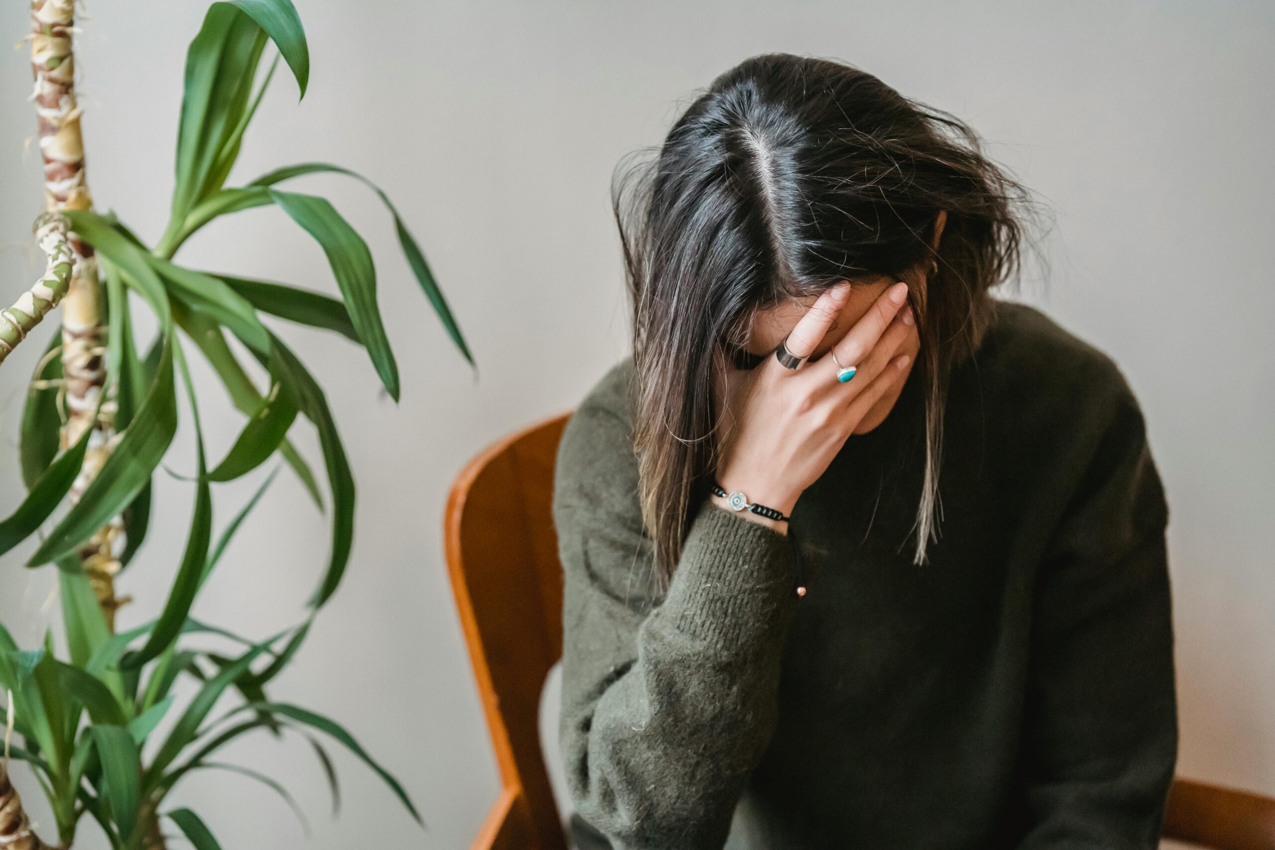 woman clutching face in distress