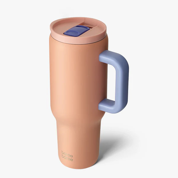 A peach portable water bottle with purple handle
