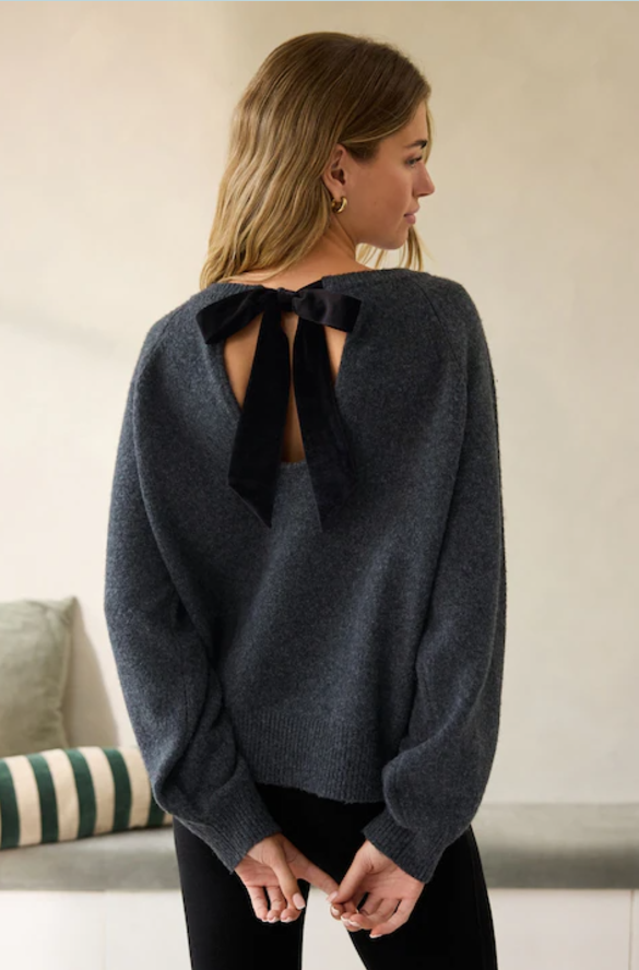 Woman models back bow jumper from Next