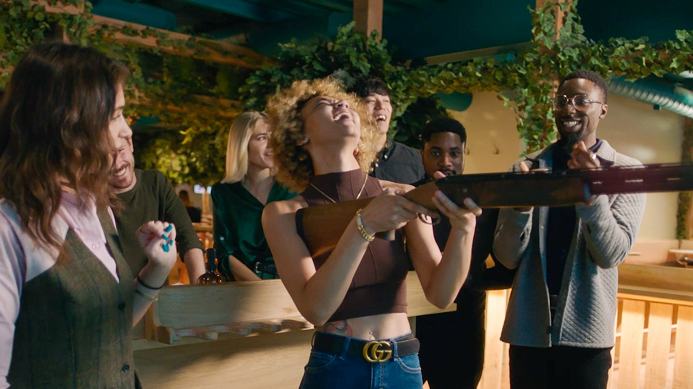 woman laughing while virtual shooting at a bar