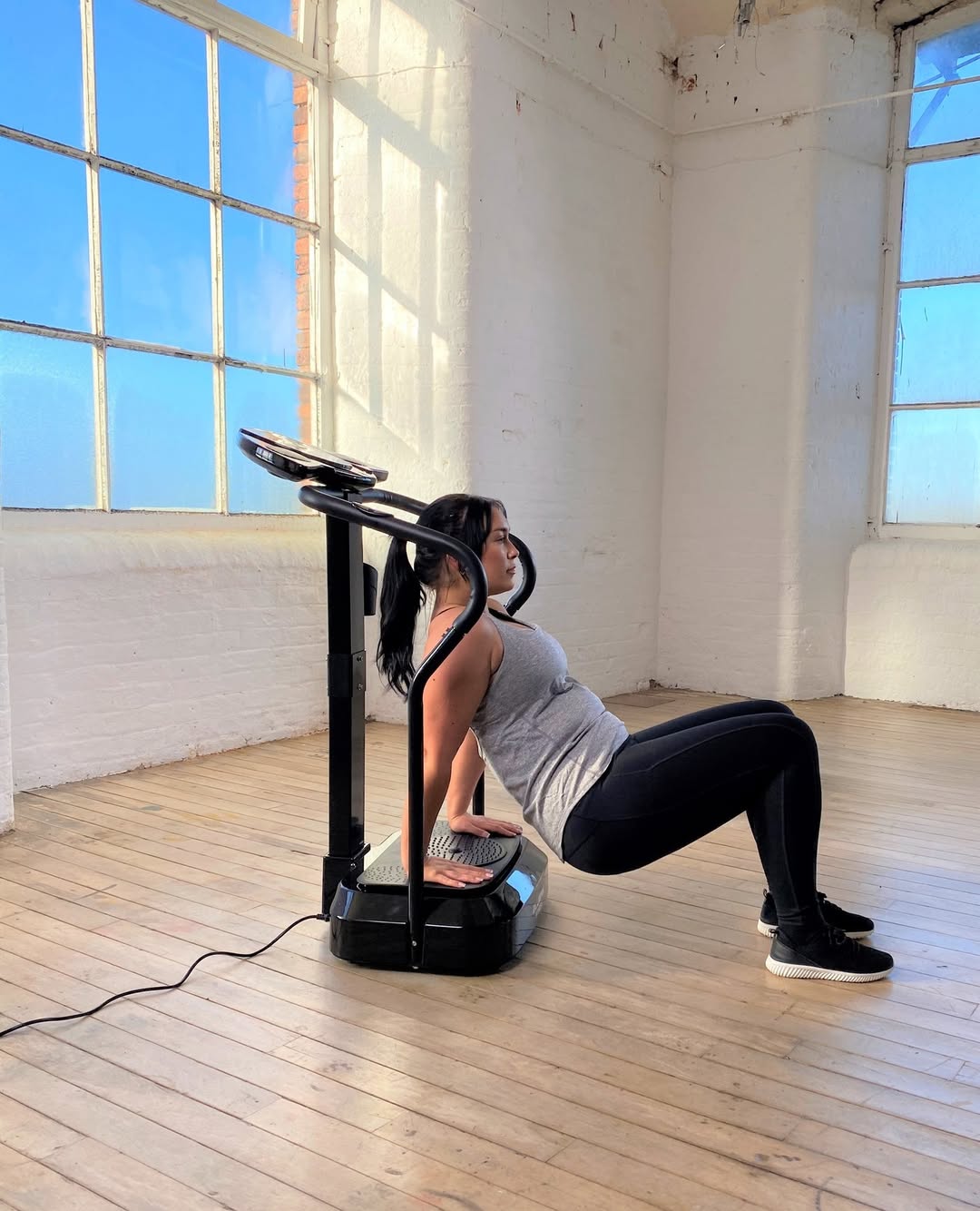 Woman uses a vibration plate