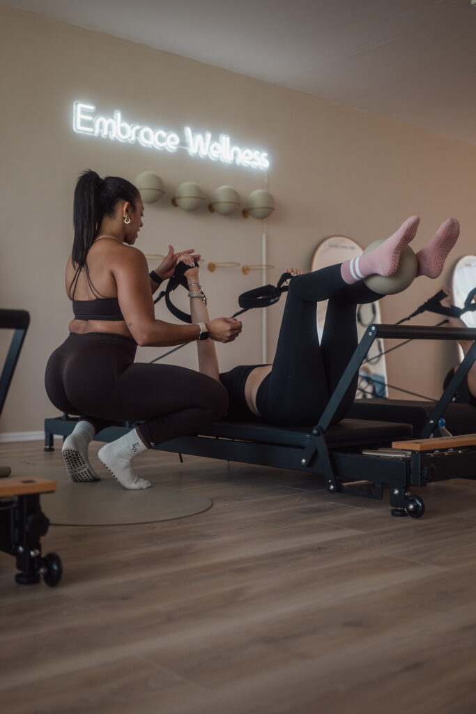 Ellie Downie instructs a Pilates class in her studio