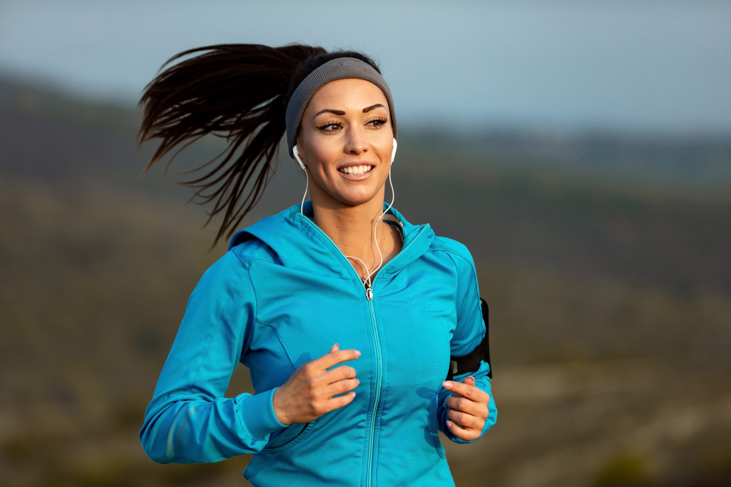 Woman smiles as she jogs