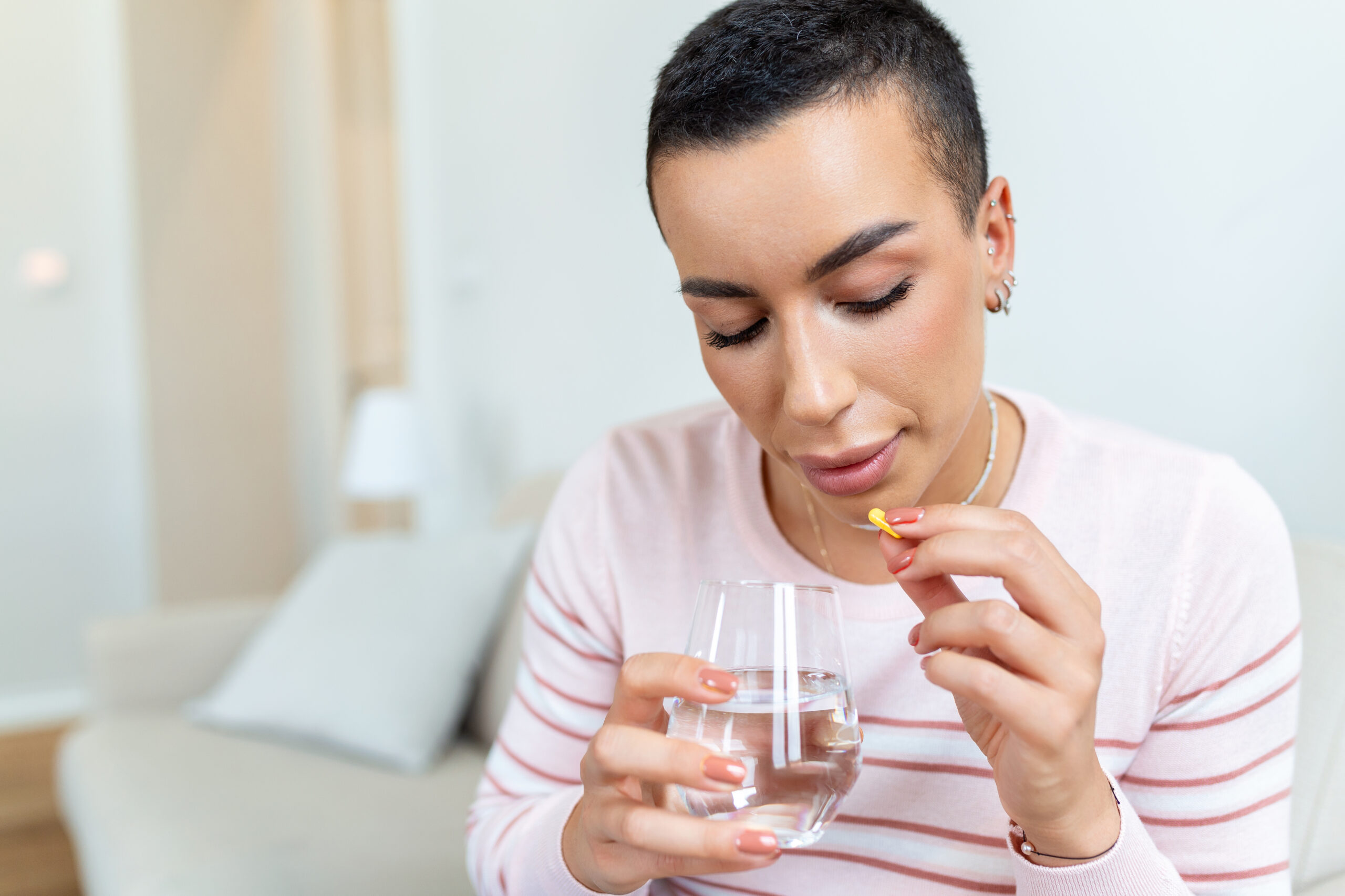 Woman takes an omega-3 supplement