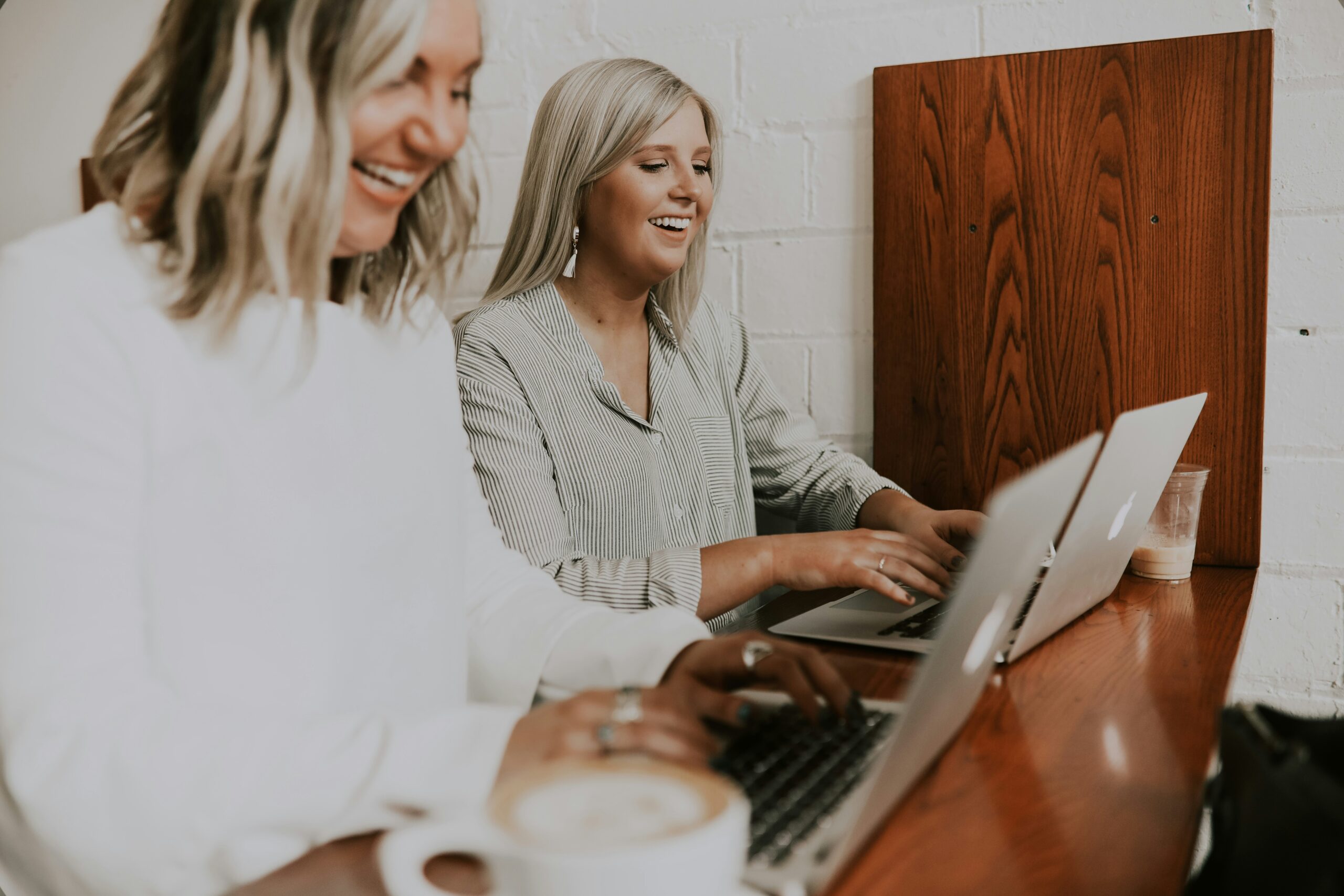 Two young women smiling at work