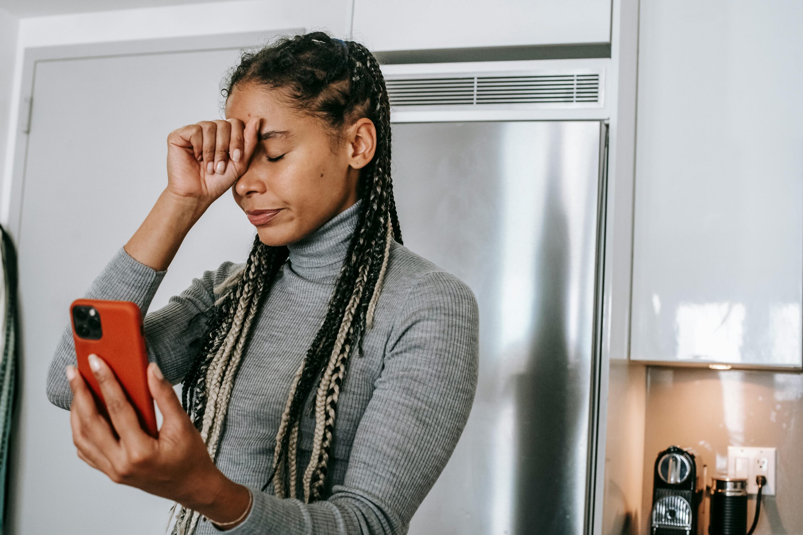 Woman stressed looking at her phone