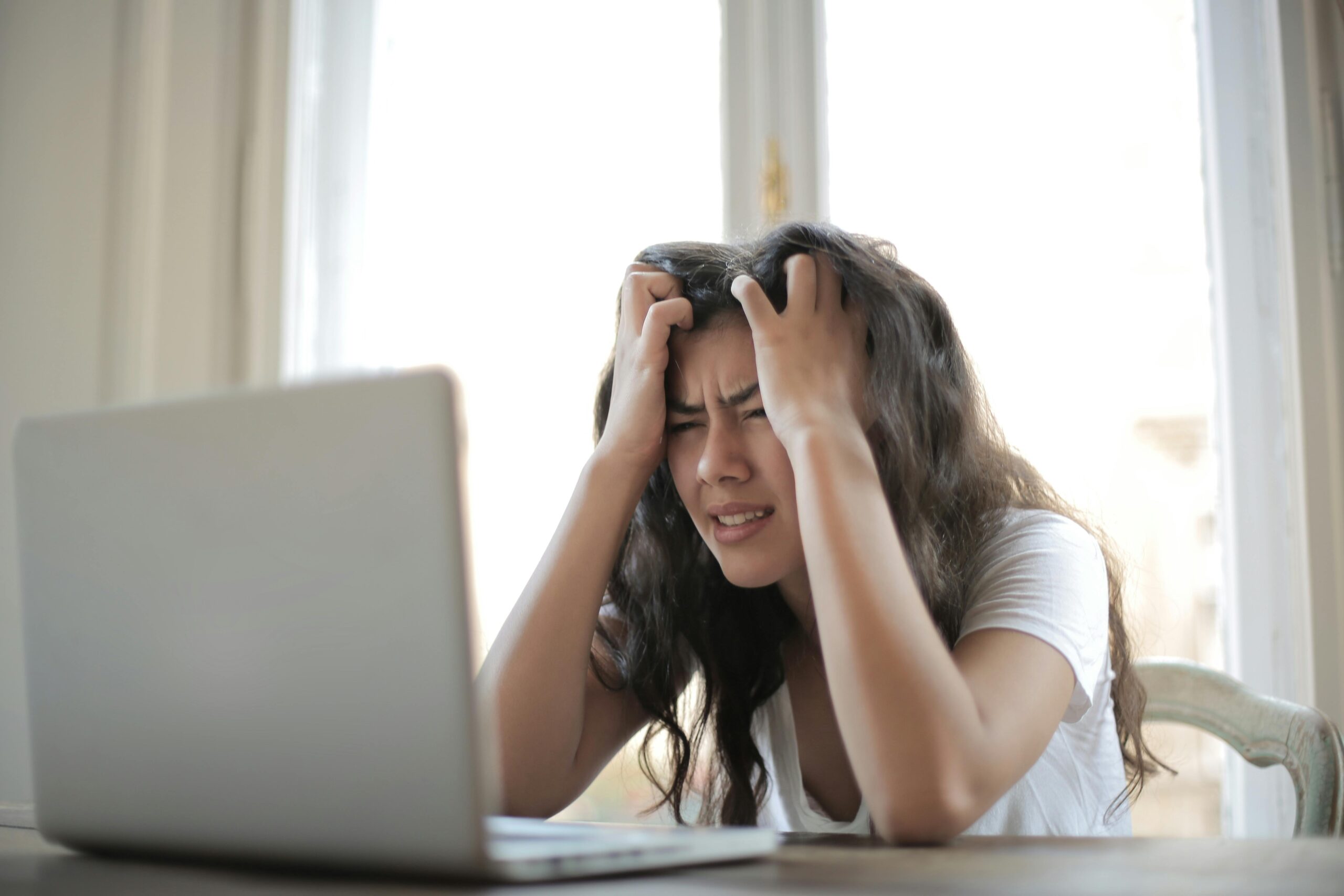 Woman stressed at her laptop