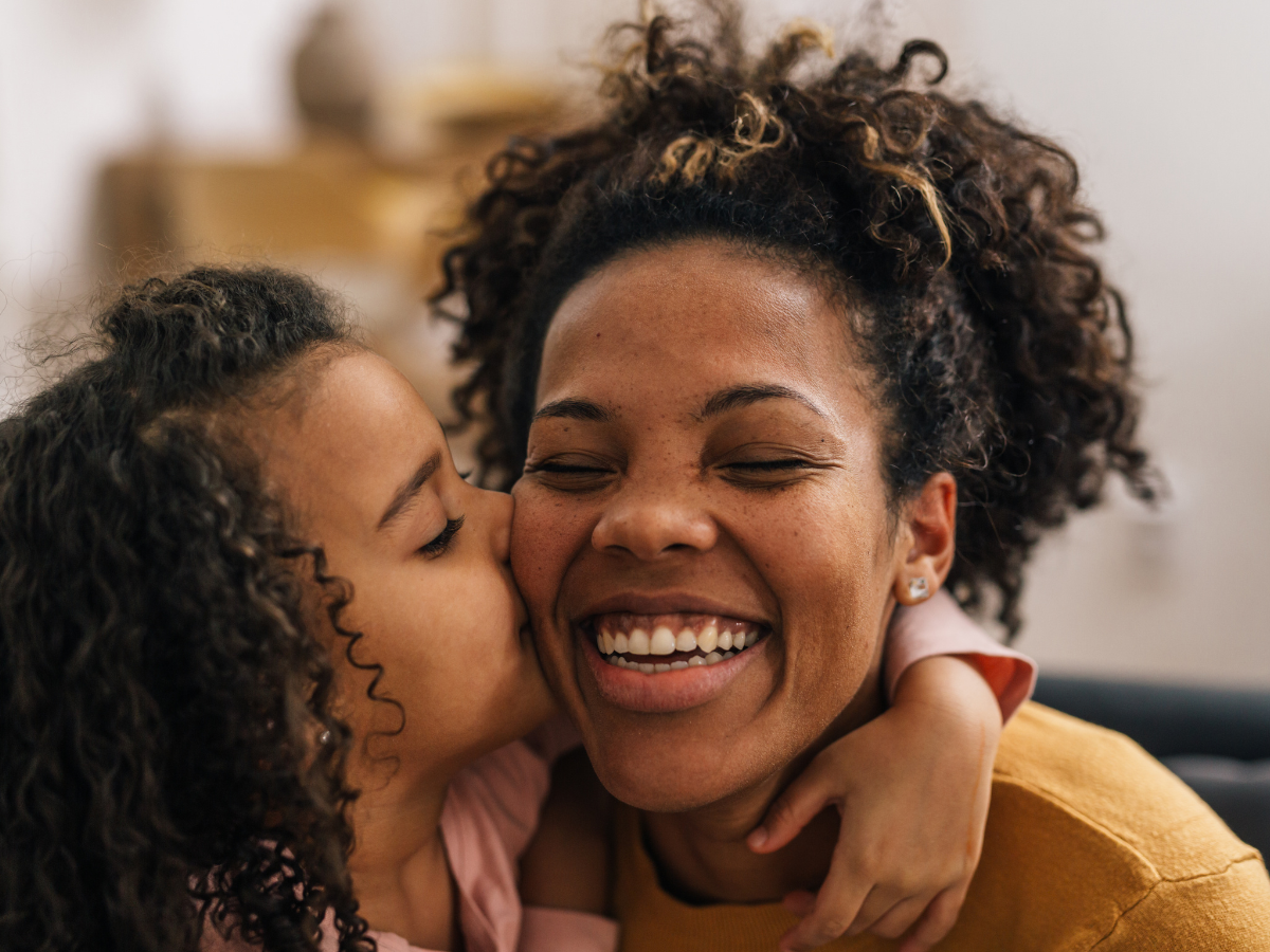 Child kisses her mother