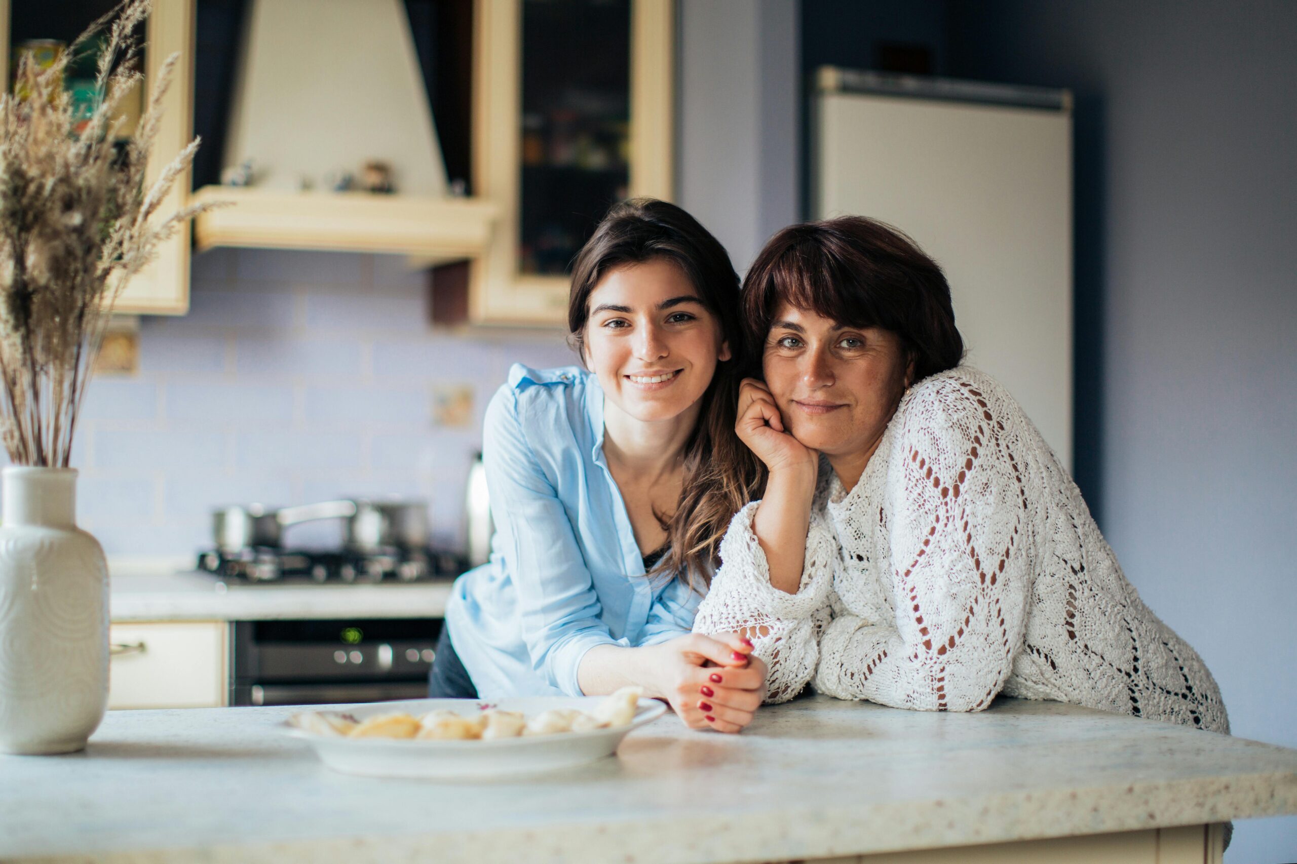 Adult daughter smiles with her mum