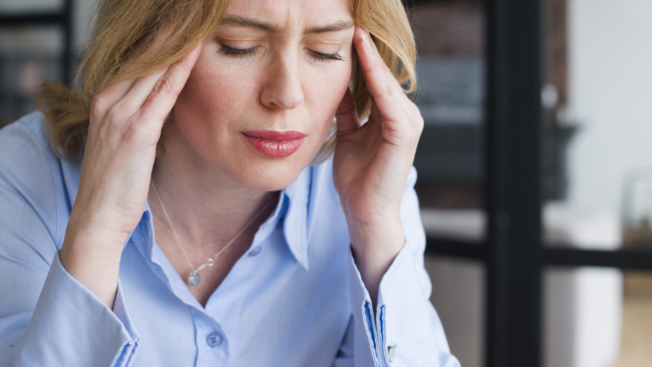 Woman suffering with a headache