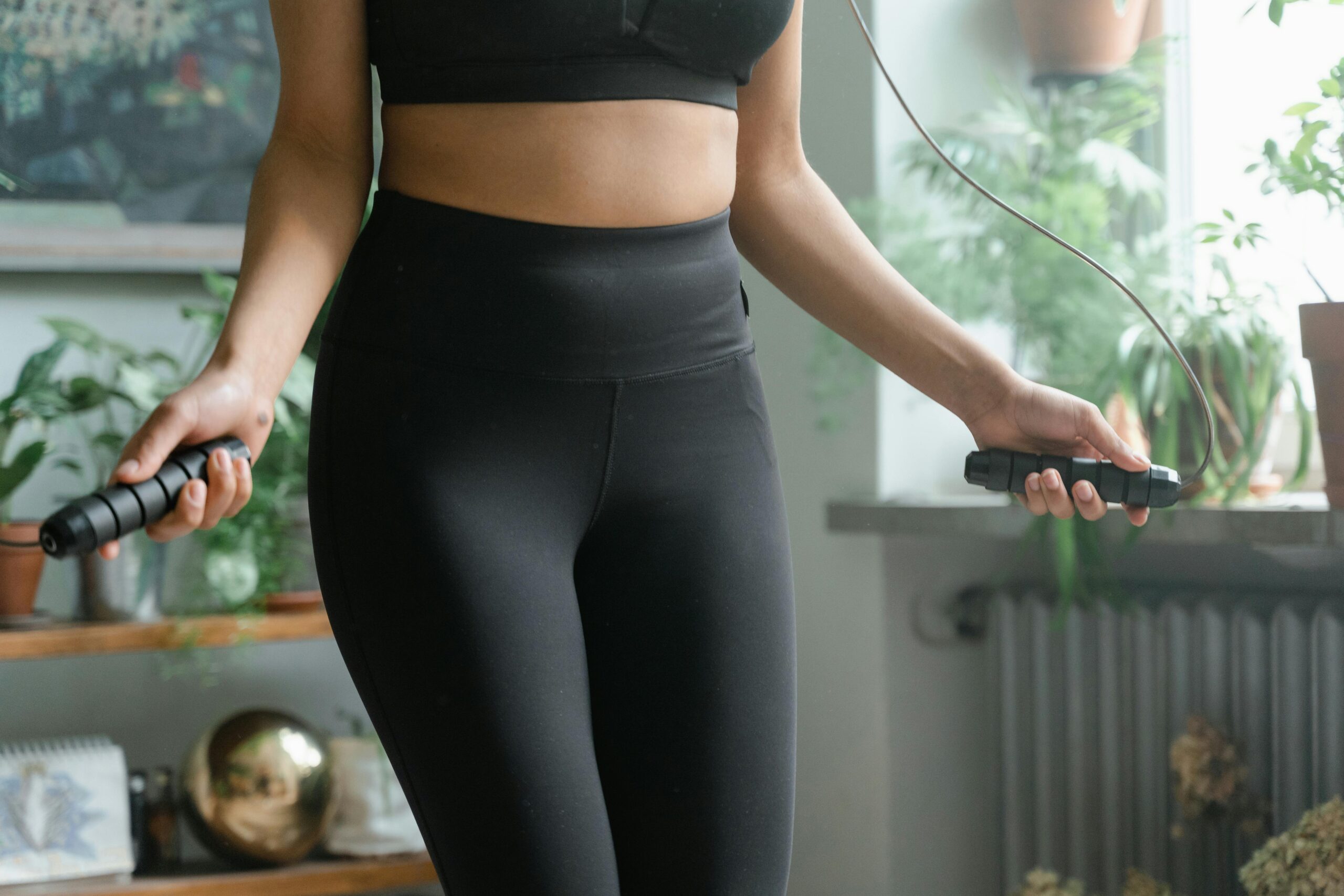 Woman skipping ropes at home