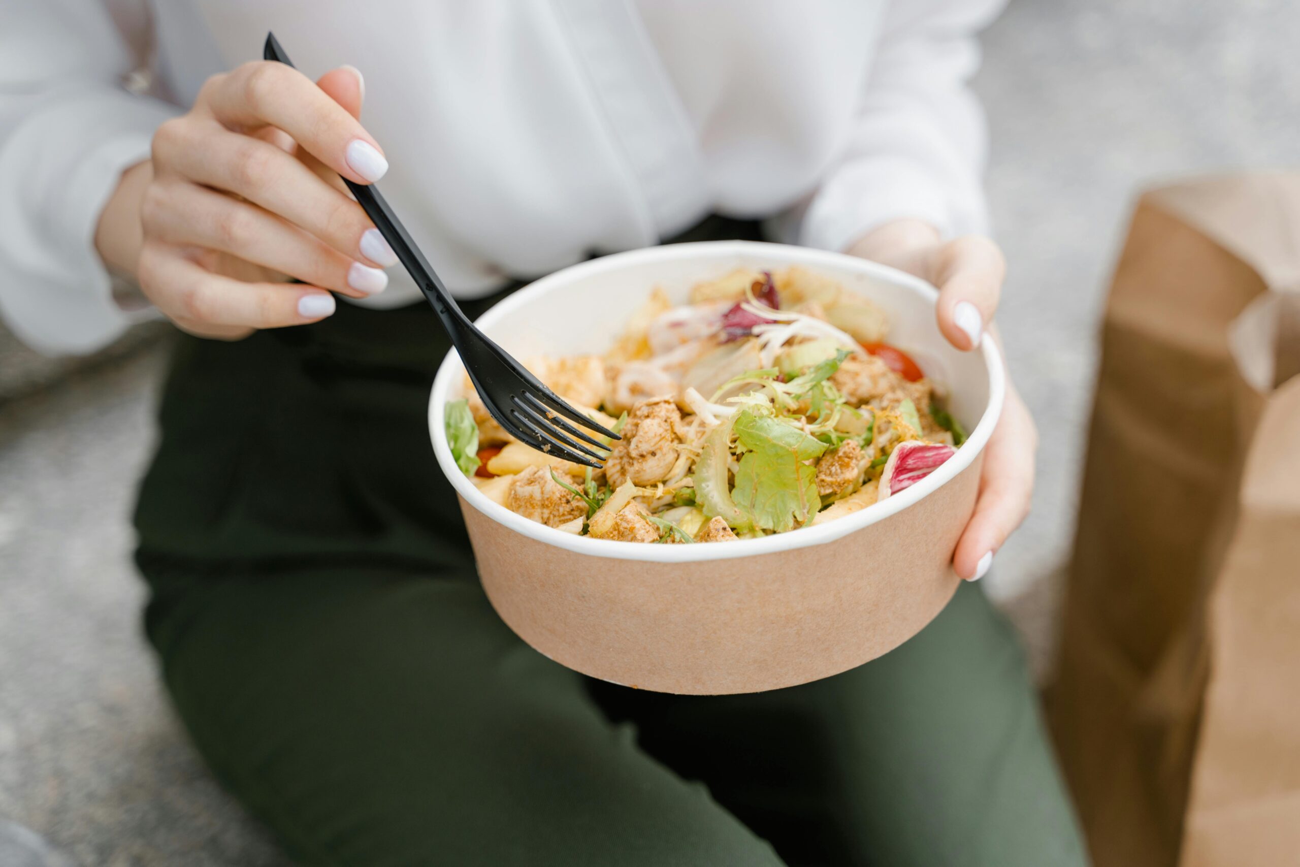 Woman eating a bowl of healthy food