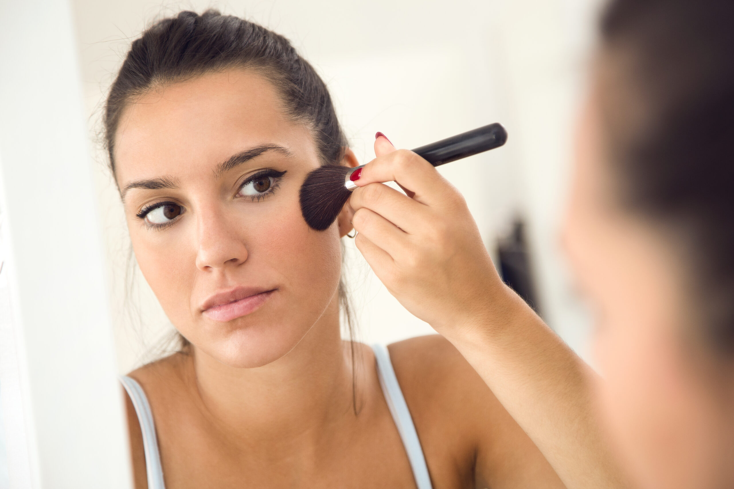 Woman applying blusher