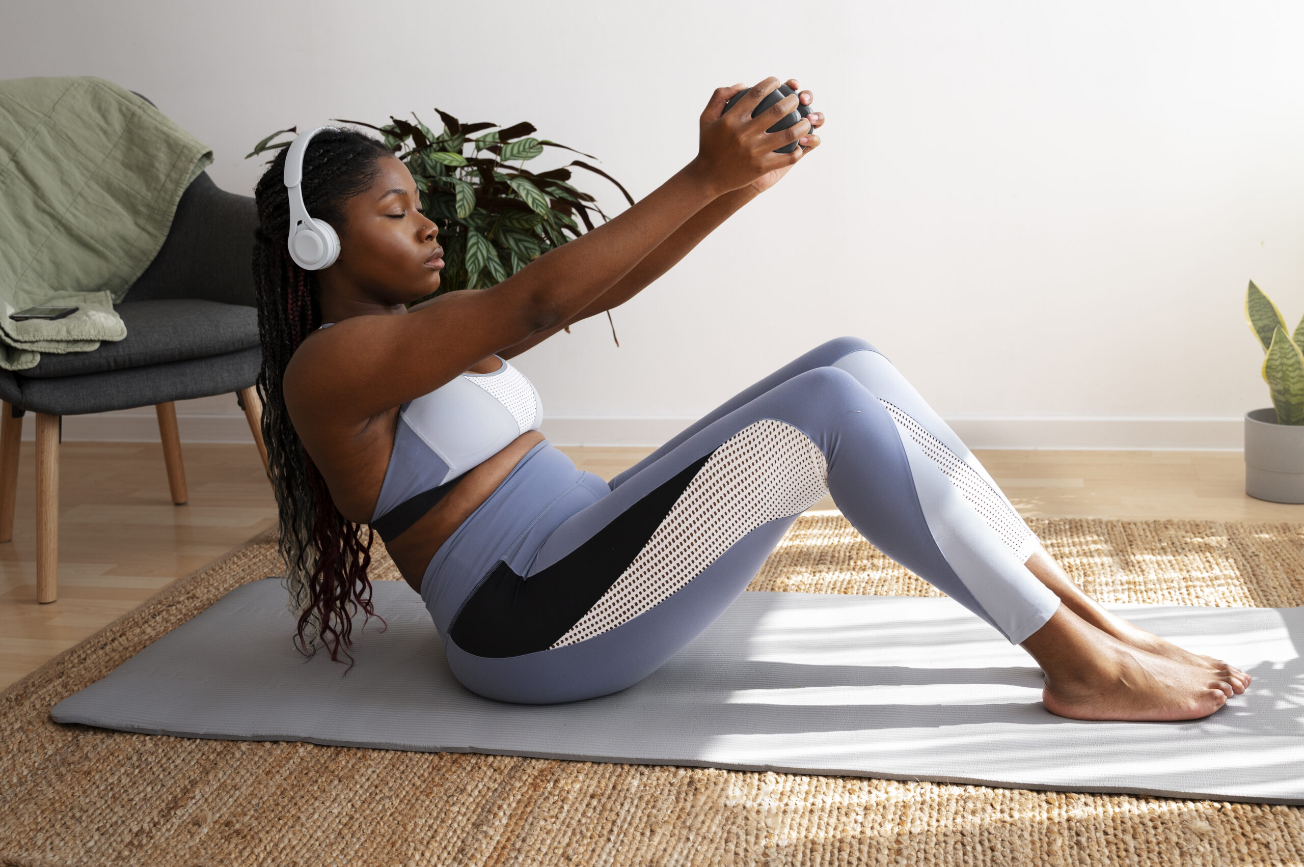Woman does weighted sit ups at home
