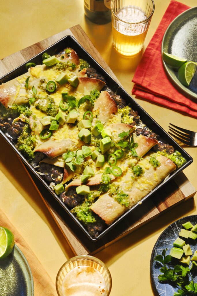 top down slanted view of a tray with baked enchiladas