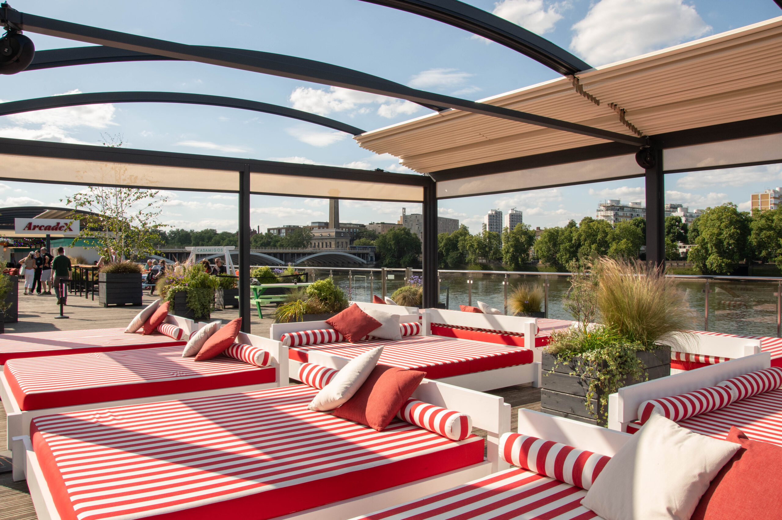 white and red striped sunloungers underneath glass roof