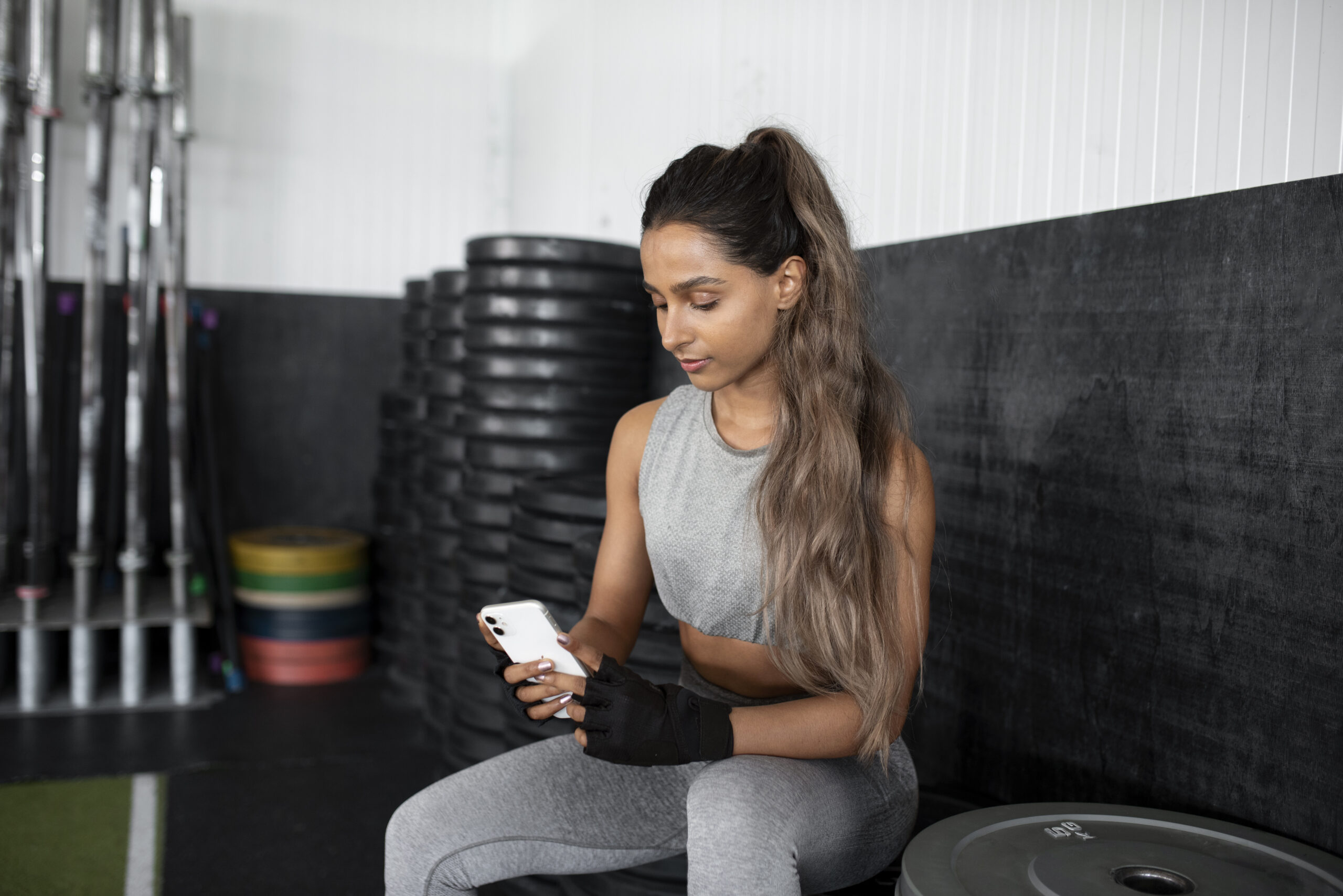 Woman texting in the gym