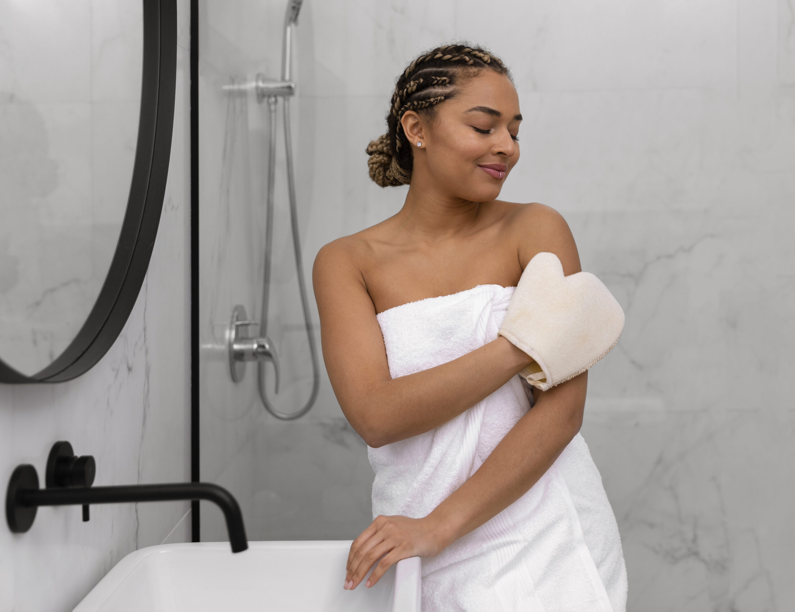 Woman dry brushing with a mitt