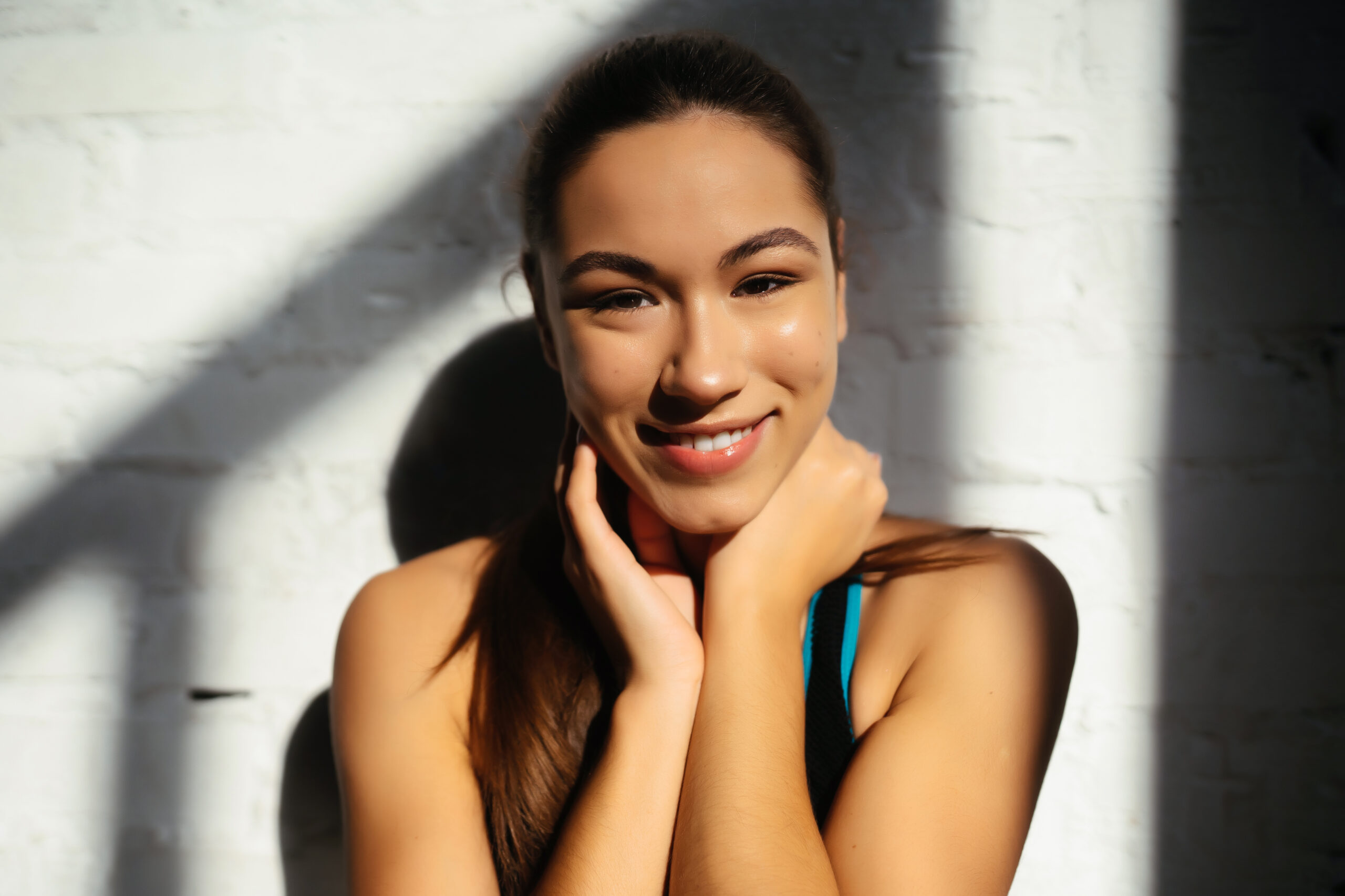 Woman smiles with glowy skin