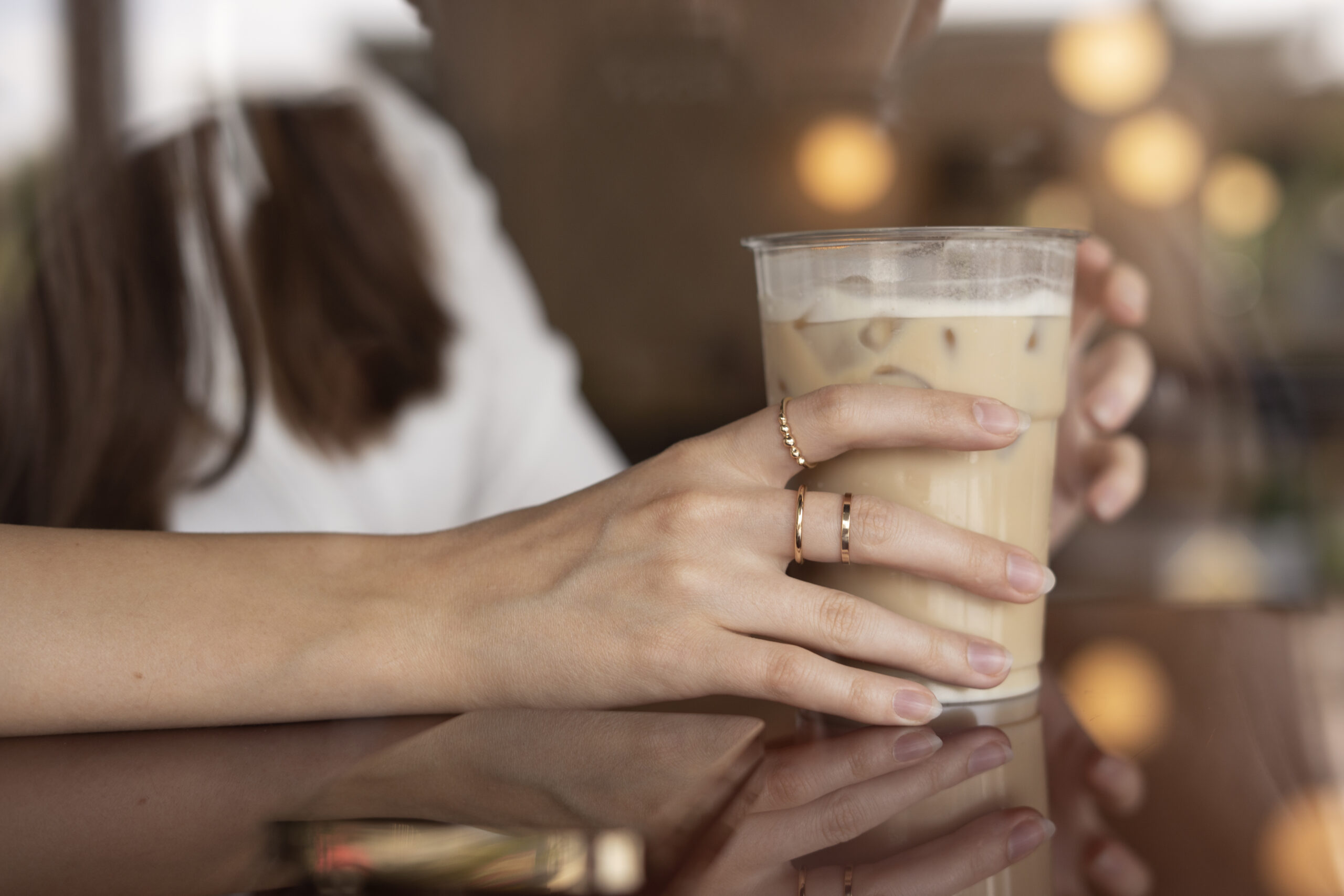 Woman drinking iced latte