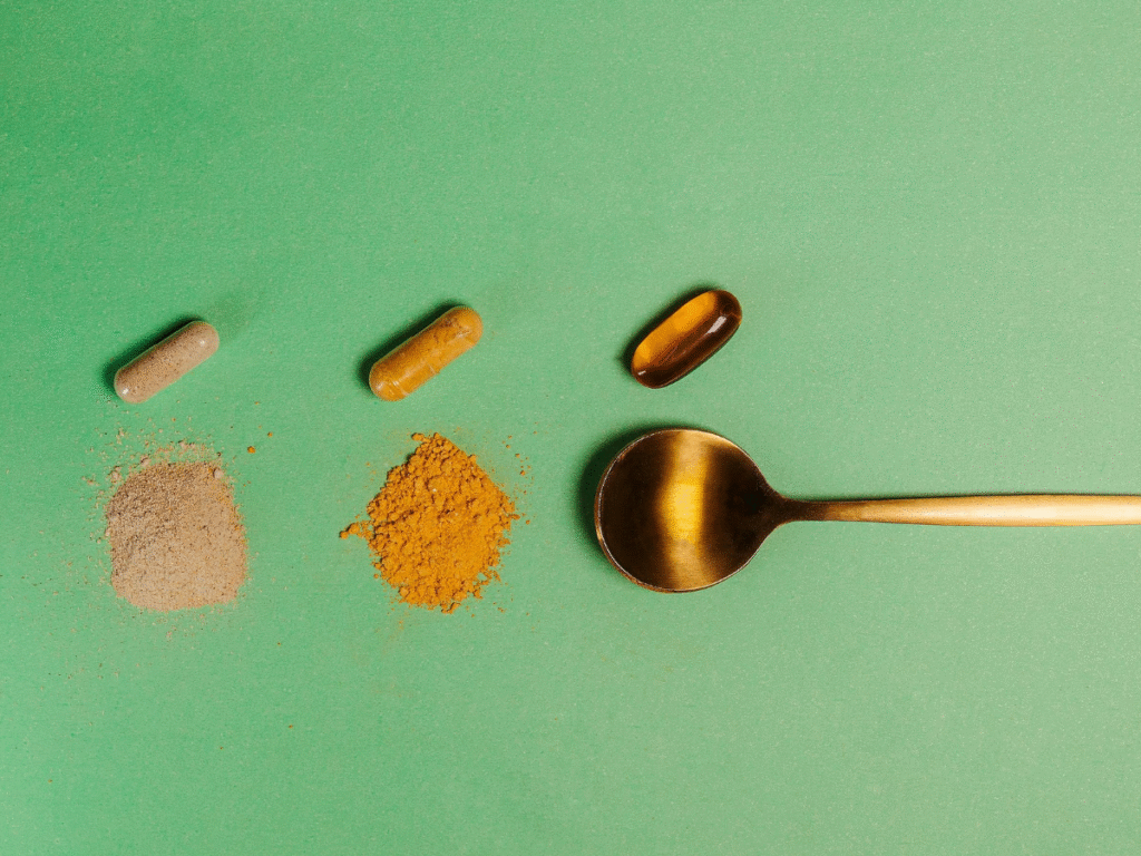 A spoon with different supplements and crushed powders