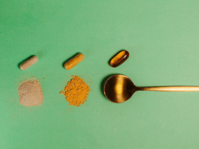 A spoon with different supplements and crushed powders