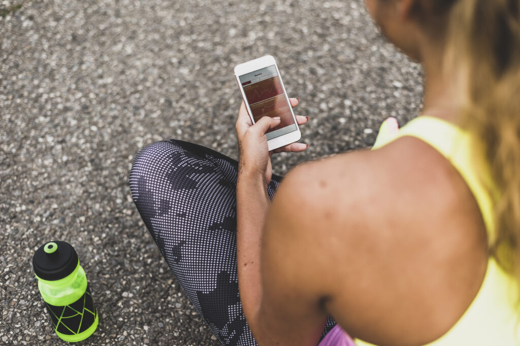 Woman using her phone during training 