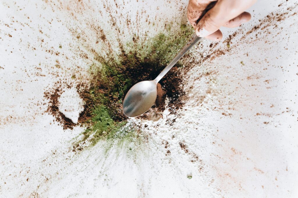 Spoon with powder underneath it 