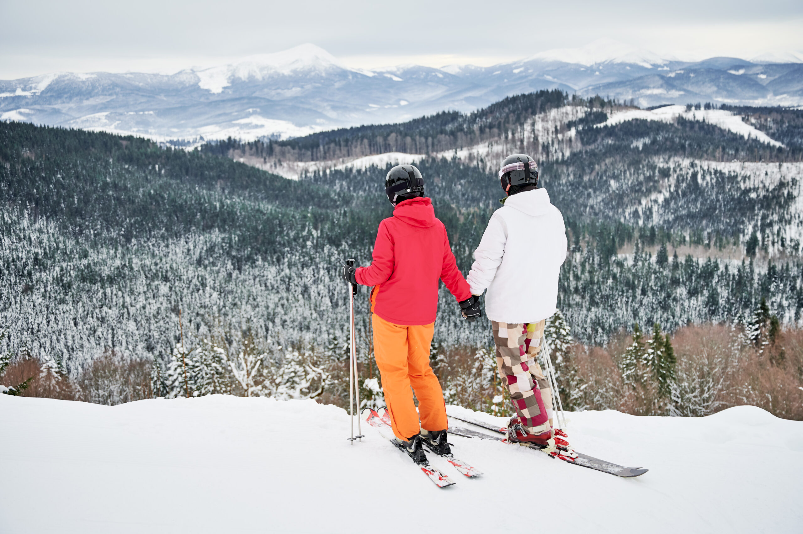 Couple look at mountain view while skiing