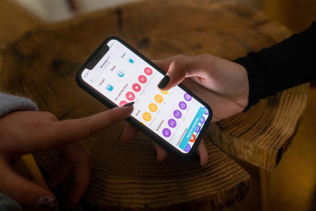 A woman using a period tracking app. 