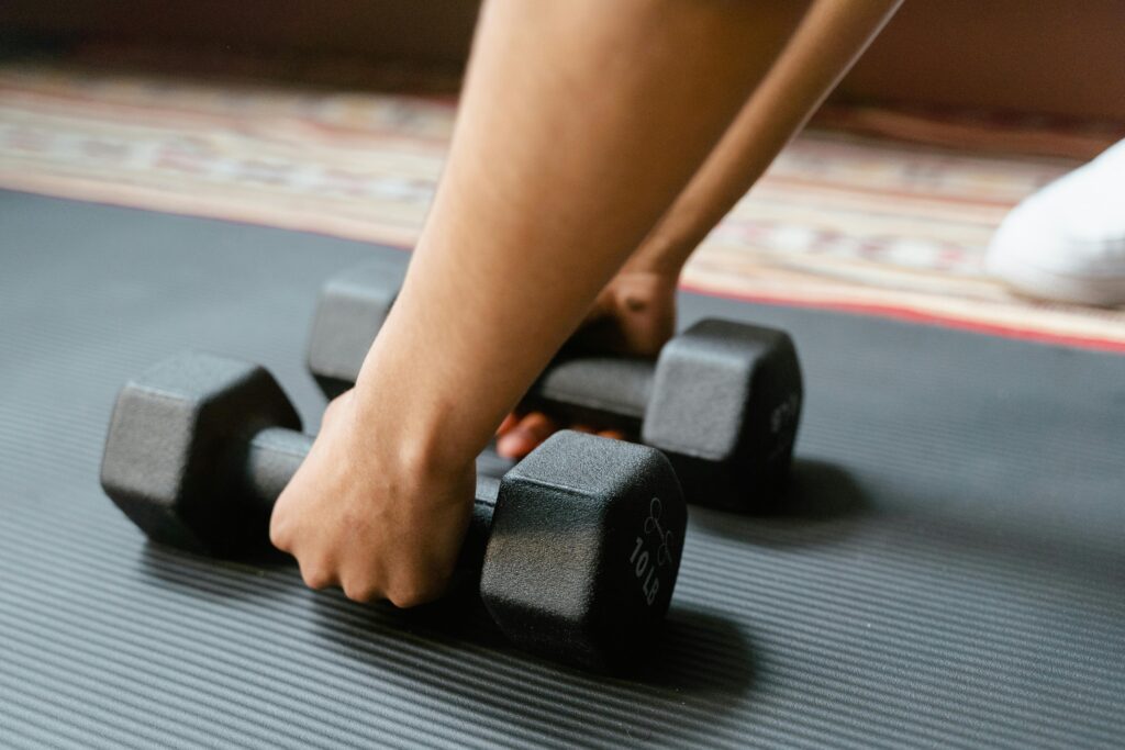 A woman picks up weights in the gym 