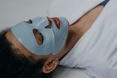 Woman lying down wearing a hydrogel face sheet mask