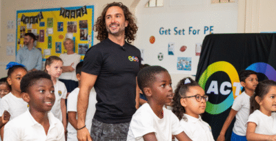 Joe Wicks teaches an exercise class in a school
