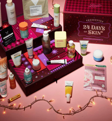 Boots 24 Days of Skincare Advent Calendar pink, lots of mini products all over the table and on the box which is stood up and opened