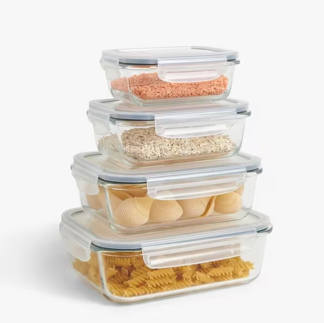 Glass food storage containers of different sizes stacked on top of each other.