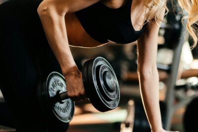 Woman lifts dumbbell in gym