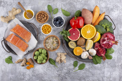 An array of food which support a healthy immune system. It includes salmon, citrus fruit and red peppers.