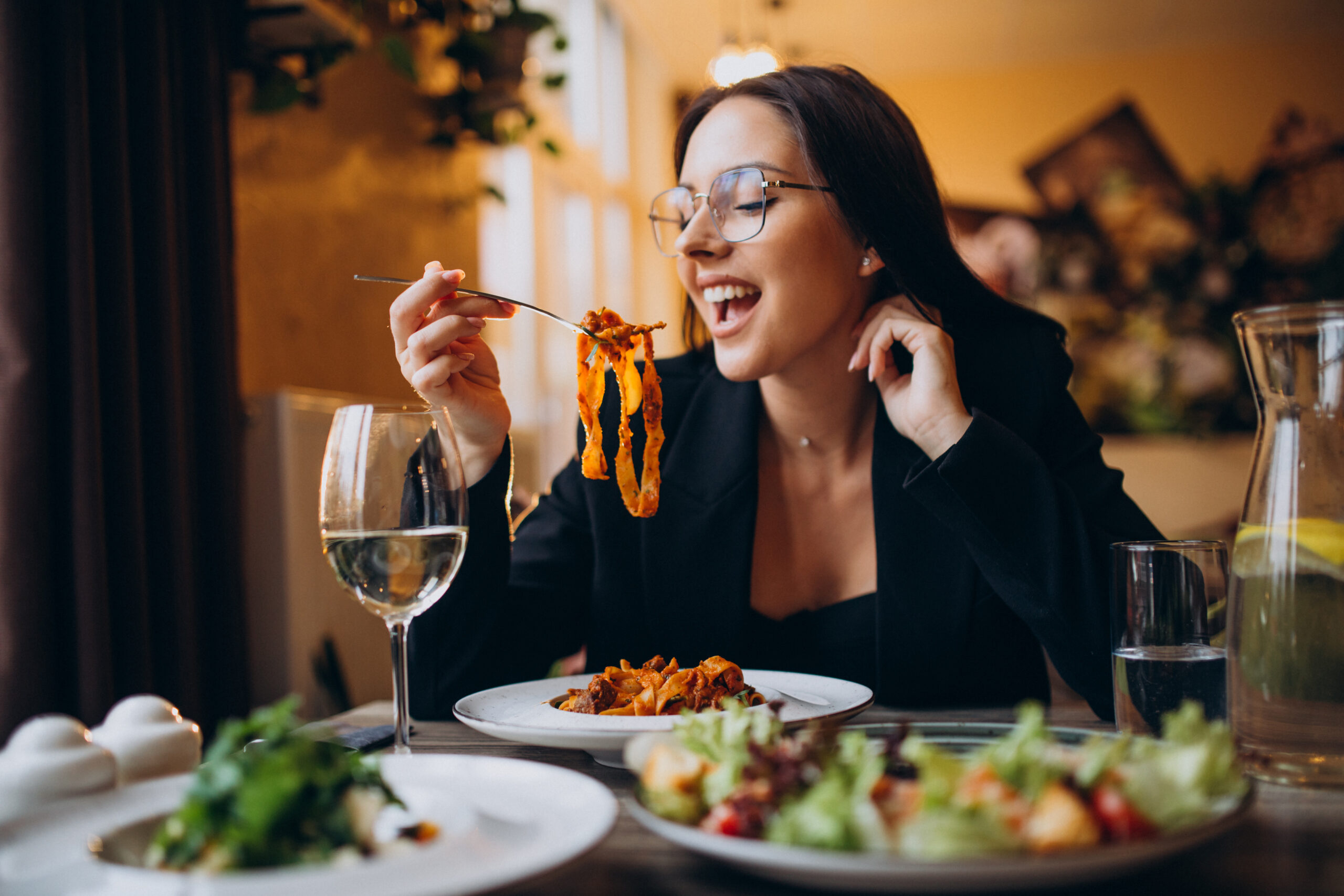 Woman eating pasta