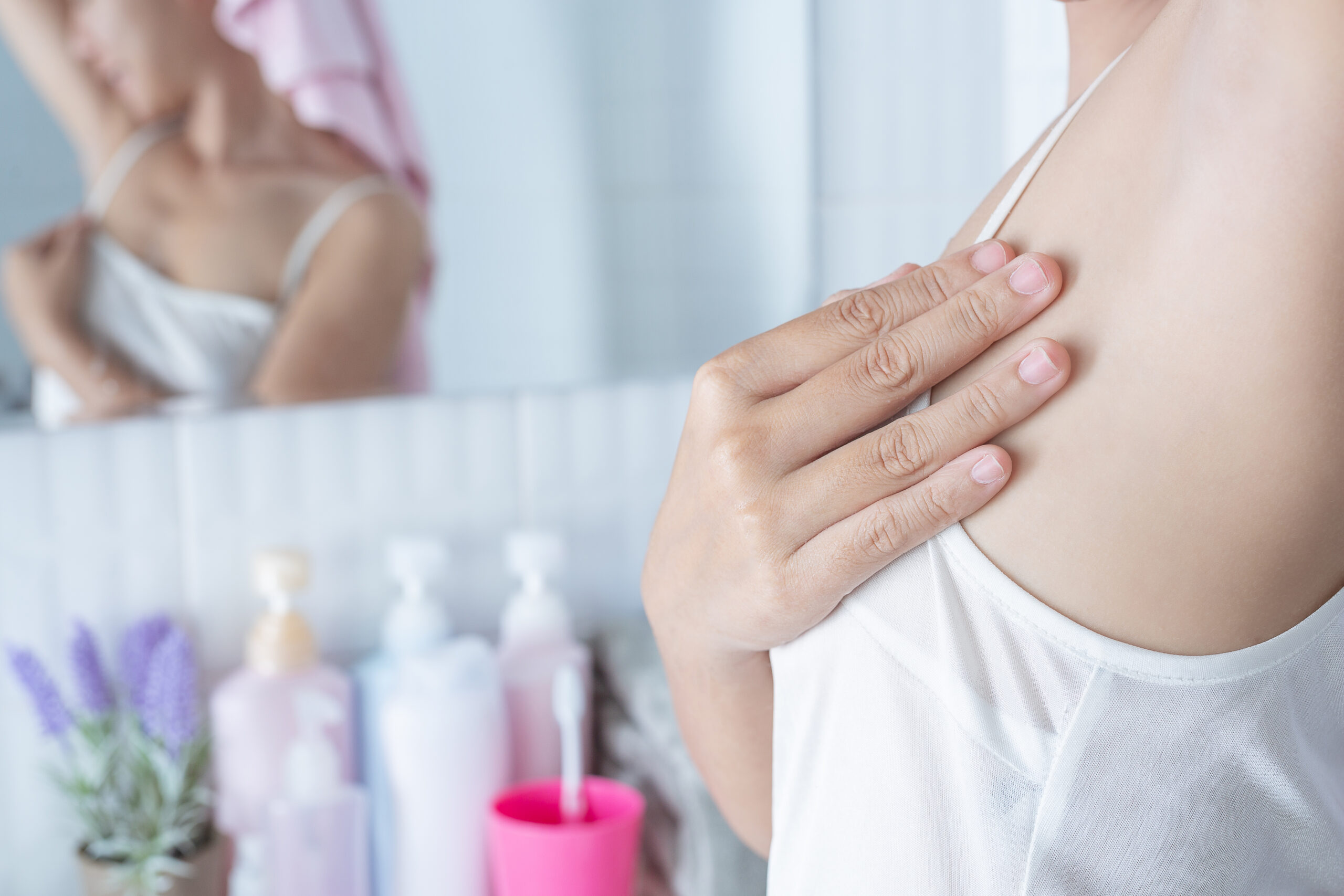 Woman checking for lumps on her breasts