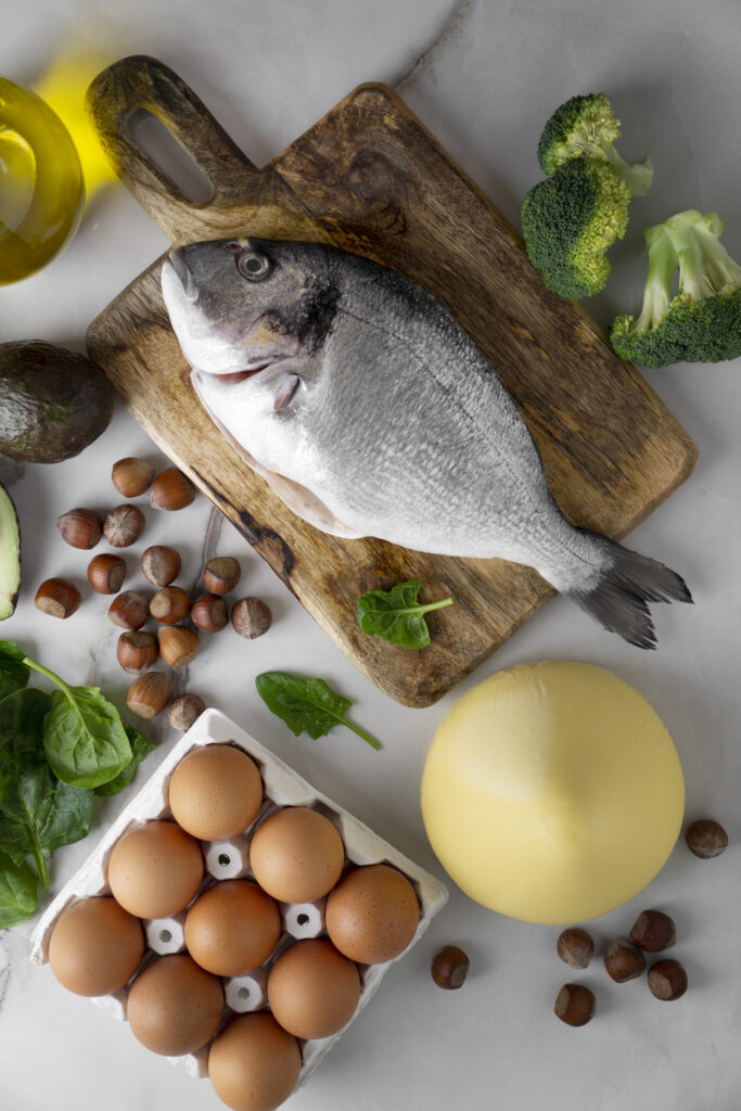top down view of table with eggs, fish and broccoli for vitamin D