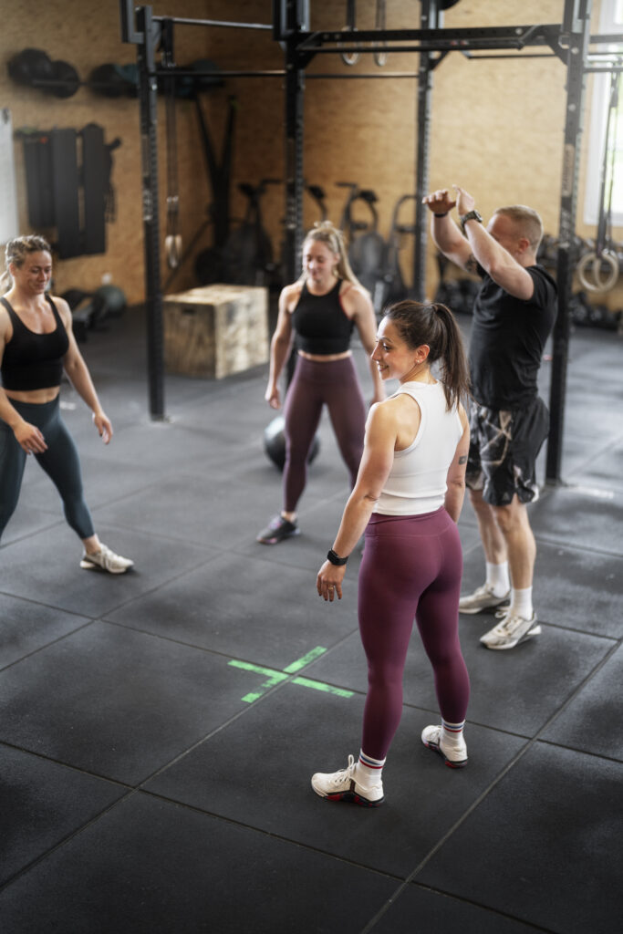 four people standing around in a gym class