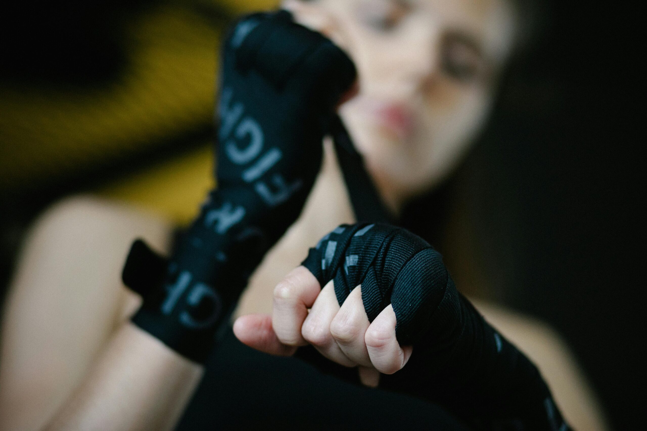 woman's hands strapping in boxing gear