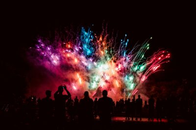 Crowd of people watching outdoor fireworks display