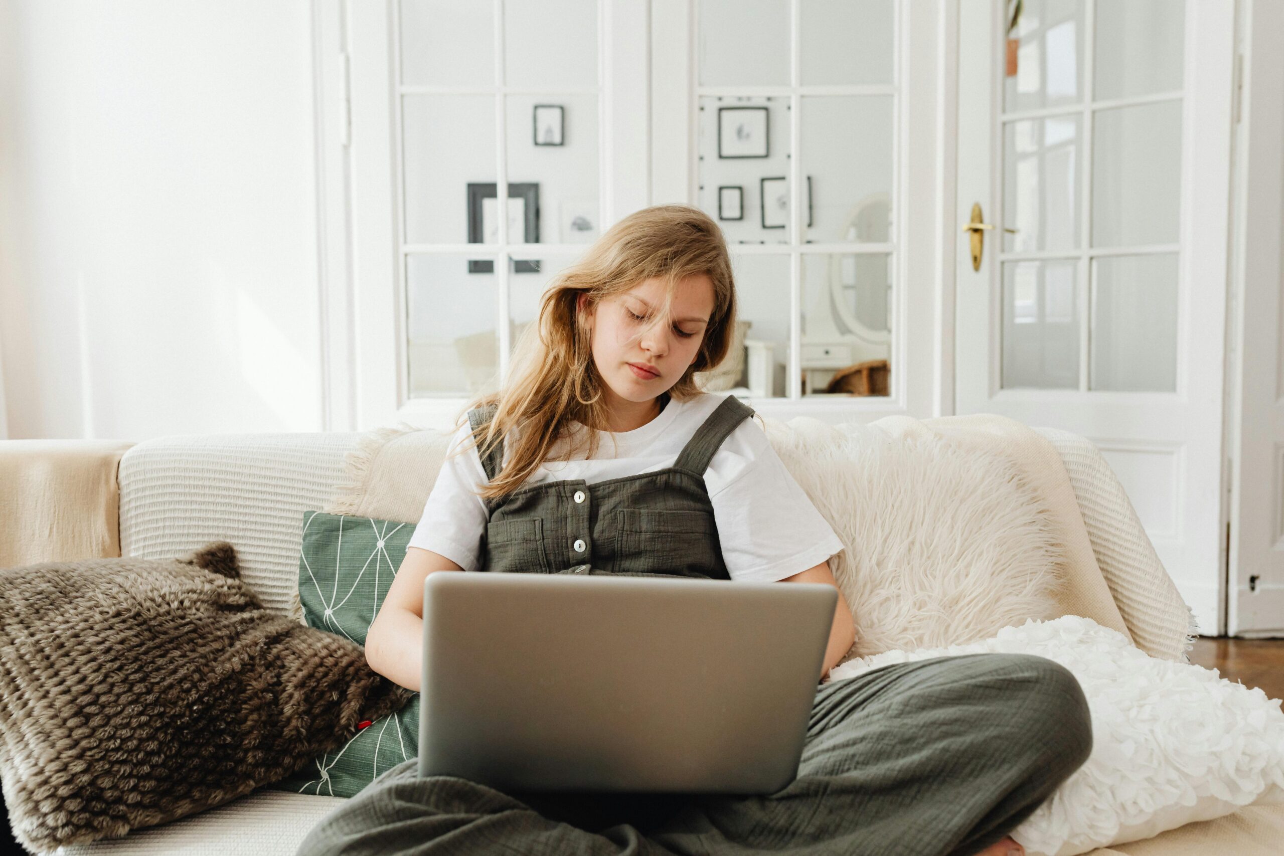 woman at laptop in white home
