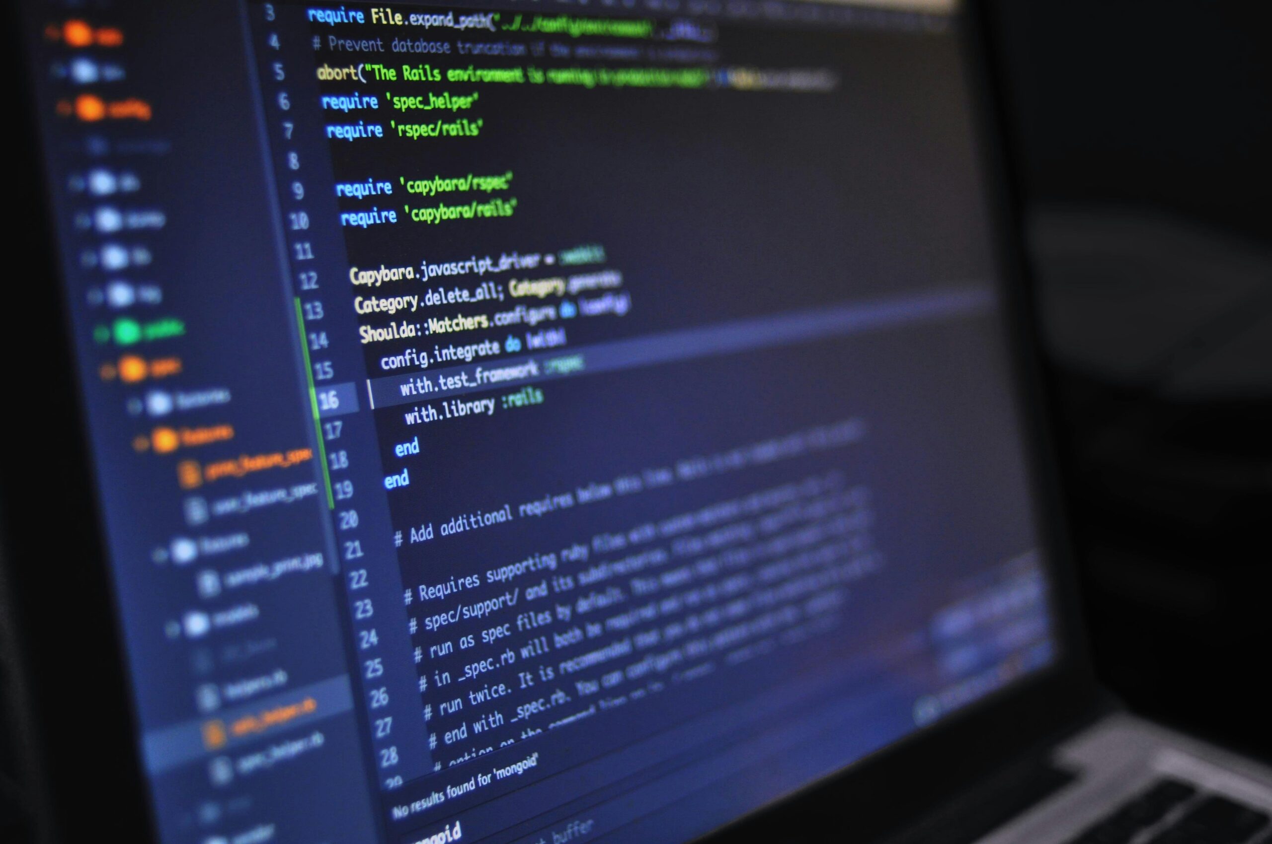 dark laptop screen with code