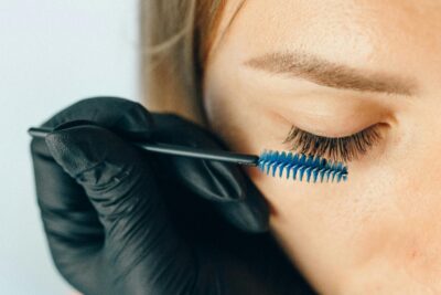 Close up of eyelash extensions brushing with spoolie