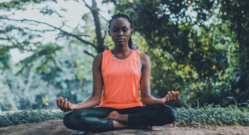 Woman practising yoga in forest