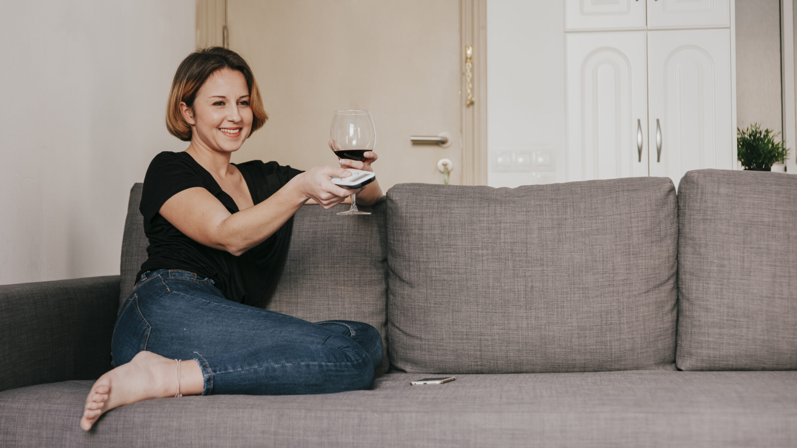 Woman on the sofa with wine