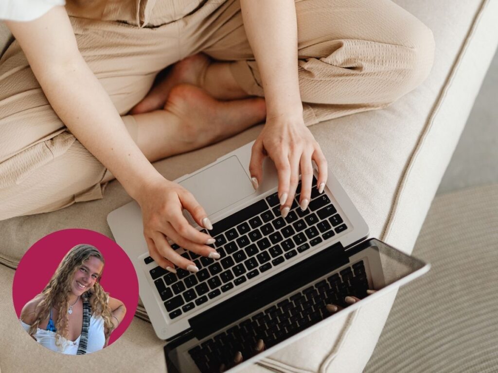 A woman types on a laptop screen.